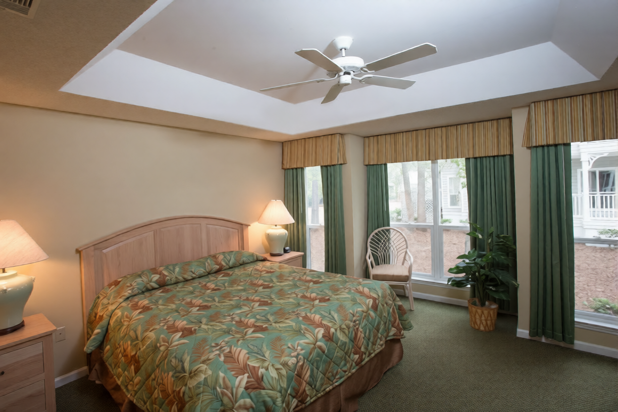 The master bedroom, with a king bed and a tray ceiling